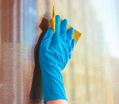 Washes the glass of a large window. Stock Photos