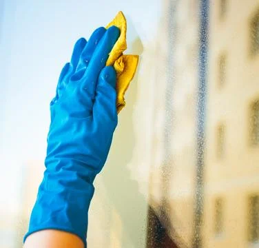 Washes the glass of a large window. Stock Photos