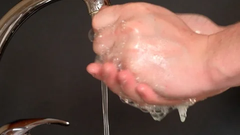 Washes hands with soap under running water Stock Footage 127107896