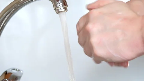 Washes hands with soap under running water Stock Footage 127107918