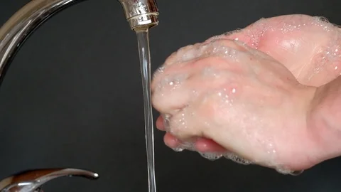 Washes hands with soap under running water Stock Footage 127107970
