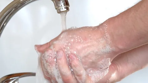 Washes hands with soap under running water Stock Footage 127107994