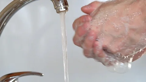 Washes hands with soap under running water Stock Footage 127108076