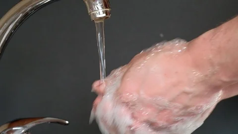 Washes hands with soap under running water Stock Footage 127108129