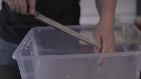 Washes the knife with water. Stock Footage 141027626