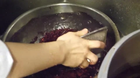 Washing and Transferring Red Azuki Beans into Large Cooking Pot in Commercial Ki Stock Footage 345293685