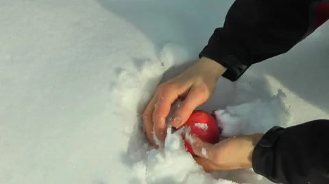 Washing an apple in snow Stock Footage 47651786