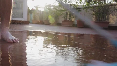 Washing the backyard patio with a mop Stock Footage 147173755
