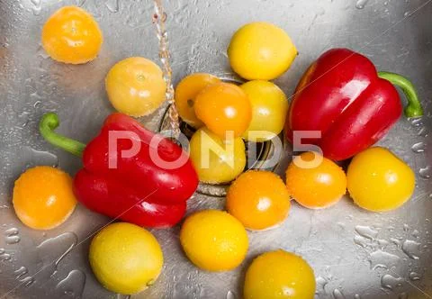 Washing bright fruits and vegetables Stock Photos