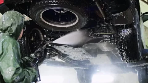 Washing the car from below with a shallow depth of field Stock Footage 219751434