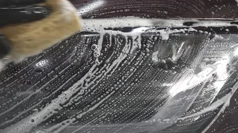 Washing car headlight with sponge close up 스톡 동영상 155846267
