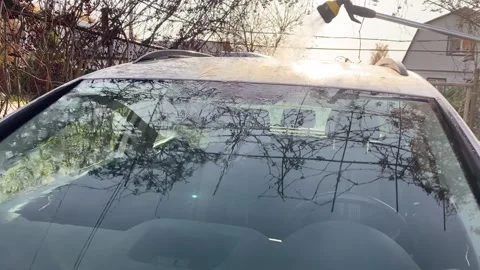 Washing the car windshield with a hose Stock Footage 319953064