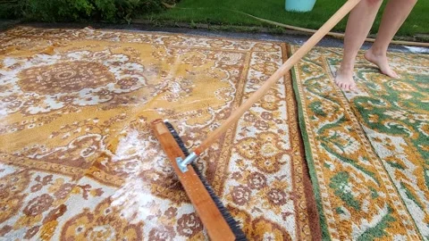 Washing carpets with a brush with detergents in the yard Stock Footage 247437565