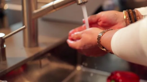 Washing cherry tomatoes by hand in the kitchen in slow motion Stock Footage 149118635