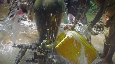 Washing clothes with belier pump help Stock Footage 103530488