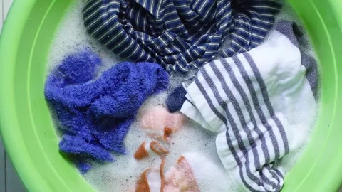 Washing clothes in a green basin with bubbles Stock Footage 340941451