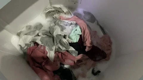 Washing clothes process inside top load washing machine Stock Footage 312399028