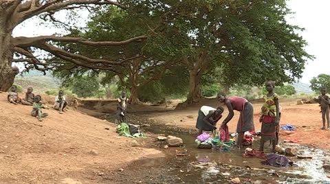 Washing Clothes in a River Stock Footage 23085397