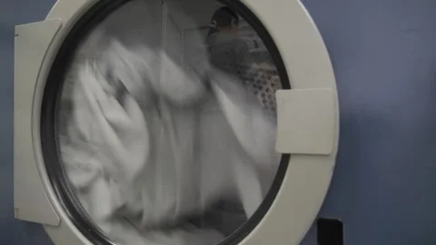 Washing clothes in a washing machine. automatic washing machine in operation Stock Footage 260970901