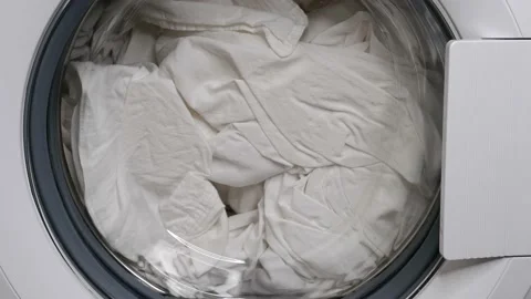 Washing clothes in a washing machine. The laundry is washed. Stock Footage 156041539