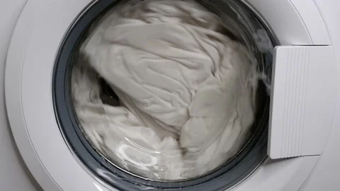 Washing clothes in a washing machine. The laundry is washed. Stock Footage 156802962