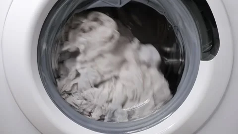 Washing clothes in a washing machine. Slow motion. Stock Footage 169948601