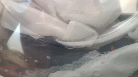 Washing colored laundry in the washing machine Stock Footage 132572265