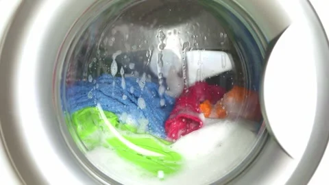 Washing colored laundry in the washing machine Stock Footage 229429319