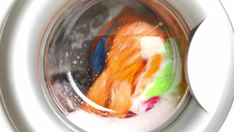 Washing colored laundry in the washing machine Stock Footage 232684532