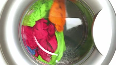 Washing colored laundry in the washing machine Stock Footage 233209457