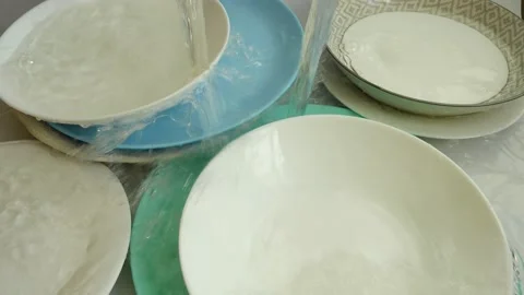 Washing dishes. Falling stream of water. Stock-Footage 168652565