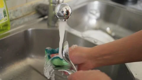 Washing dishes at home using soap and clean water is an essential domestic Stock-Footage 304679767