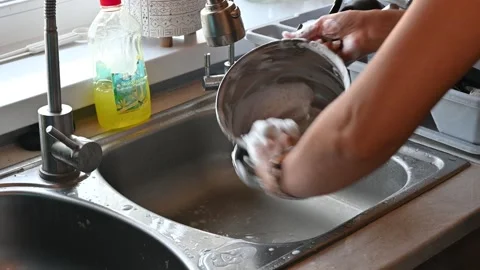 Washing the dishes in the kitchen Stock Footage 247834404