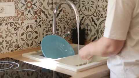 Washing dishes in a modern kitchen Stock Footage 283478234