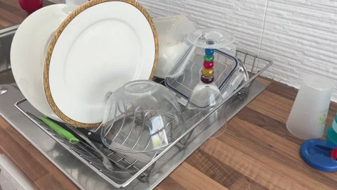 Washing Drinking Glasses and Dishes in a Kitchen Sink Stock Footage 341111357