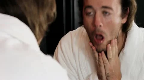 Washing face in front of mirror - HD Video stock 12235796