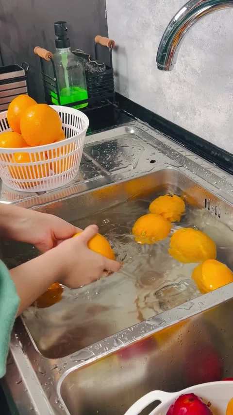 Washing Fresh Oranges, Hand Cleaning Citrus Fruit in Kitchen Sink Stock Footage 337785177
