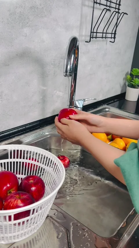 Washing Fresh Red Apples in Modern Kitchen Sink for Healthy Nutrition Stock Footage 337730204
