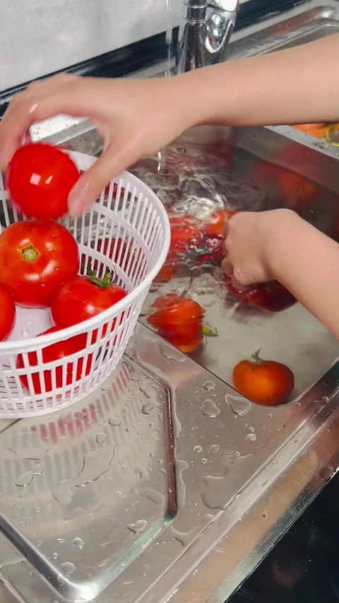 Washing Fresh Red Tomatoes in Kitchen Sink Stock Footage 338157924