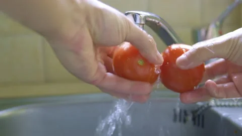 Washing fresh tomatoes in the kitchen , close up shoot Stock-Footage 219623600