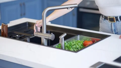 Washing fresh vegetables in a kitchen sink Stock Footage 336466074