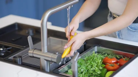 Washing fresh vegetables in kitchen sink Stock Footage 336466096