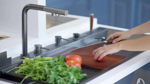 Washing fresh vegetables in a kitchen sink Stock Footage 336466108
