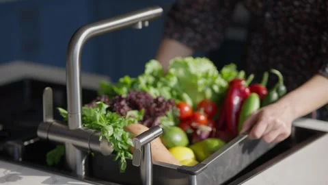 Washing fresh vegetables in kitchen sink Stock Footage 336466120