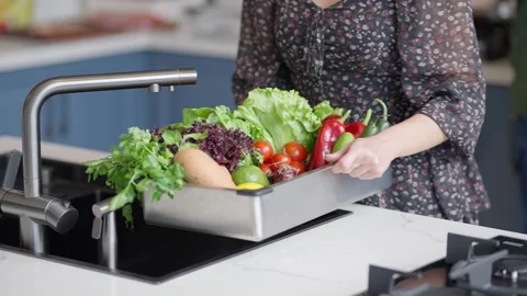 Washing fresh vegetables in a kitchen sink Stock Footage 336466165