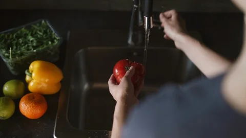 Washing fruit and vegetables to remove pesticides. Stock Footage 128551846