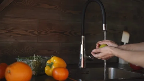 Washing fruit and vegetables to remove pesticides. Stock Footage 128551970