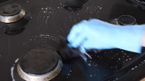 Washing gas range surface with foam and sponge Stock Footage 340285035