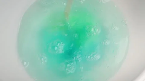 Washing gel capsule pod with laundry detergent stir with a stick in hot water Stock Footage 263136019