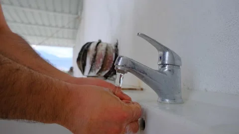 Washing of hand, hand washing at top of a roof Stock Footage 171013053